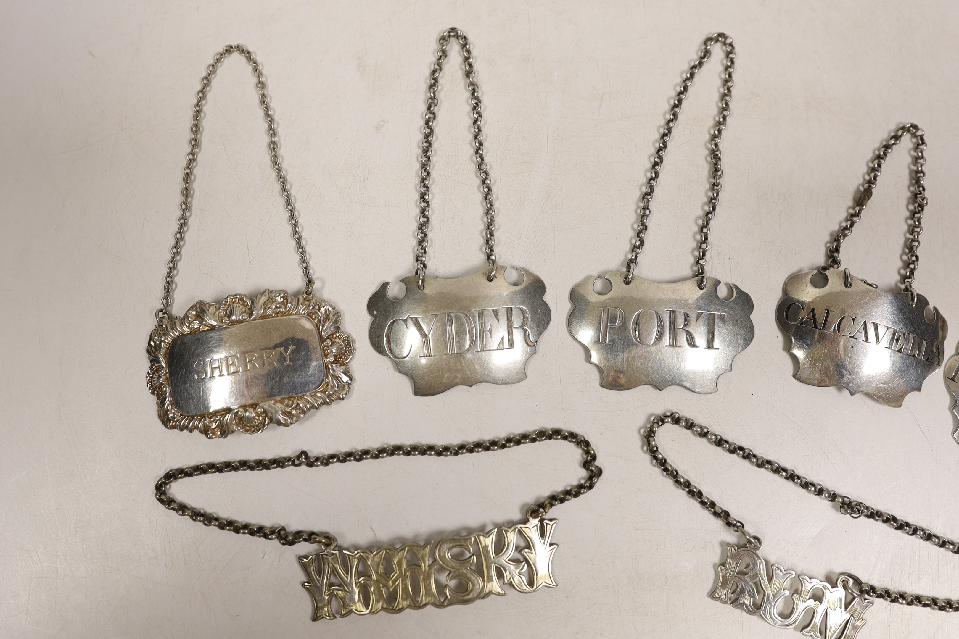 Four assorted 19th century white metal wine labels including pair 'Calcavella' & 'Port' by John Harvey I, London, circa 1750 and four assorted plated wine labels.
